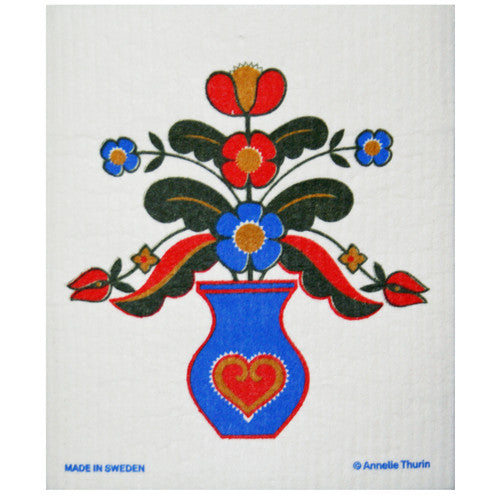 Blue vase with red heart, floral design, Swedish dishcloth, white background.
