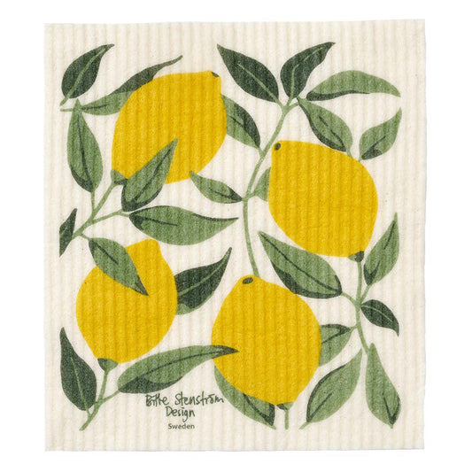 Yellow lemons and green leaves on a white, textured dishcloth.
